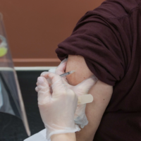 Australia joins vaccination leaders as COVID runs rampant